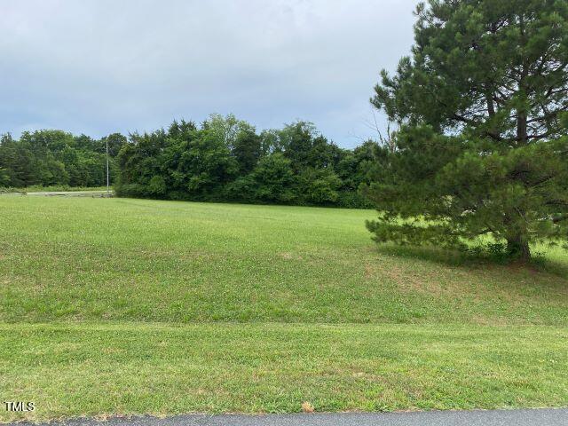 4524 West Millstone Drive Burlington, NC 27215 - Photo 8 of 22 a view of a field with an trees