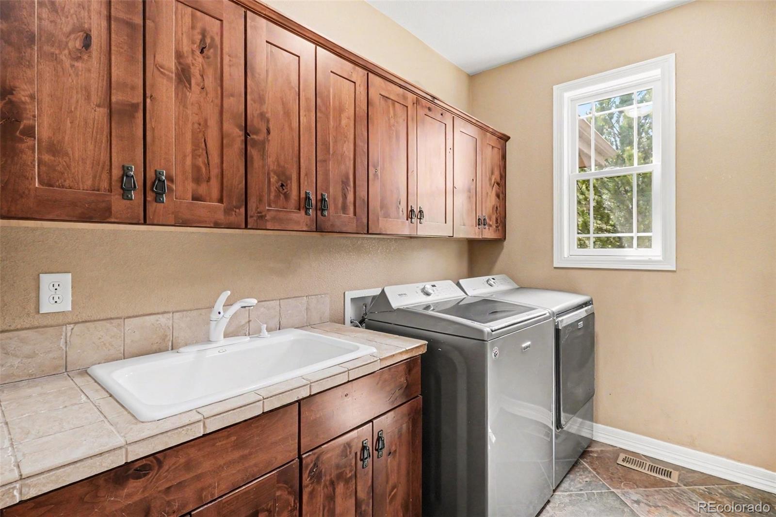 791 Elk Rest Road Evergreen, CO 80439 - Photo 31 of 46 a utility room with dryer and washer