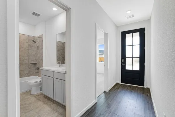 a bathroom with a toilet sink a mirror and a shower