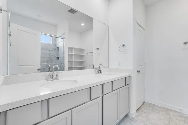 a bathroom with a sink double vanity and a mirror