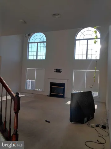 a living room with furniture a fireplace and a large window