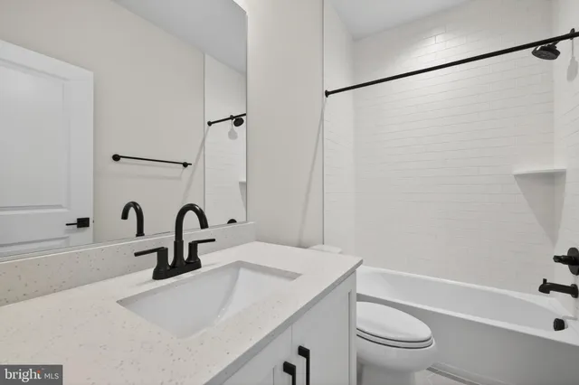 a bathroom with a sink a toilet and a bathtub