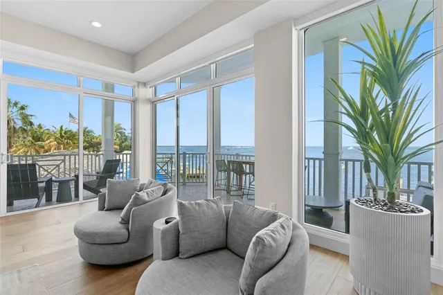 a view of roof deck with dining table and chairs with wooden fence