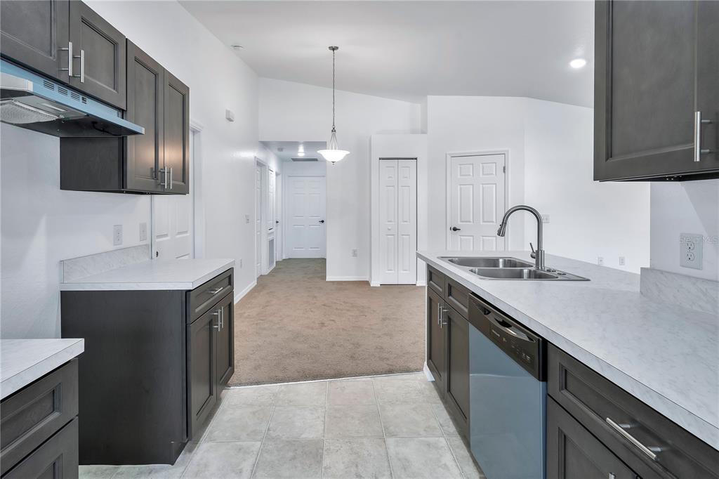 833 3rd Avenue Dundee, FL 33838 - Photo 12 of 37 a kitchen with a sink and a stove top oven with wooden floor