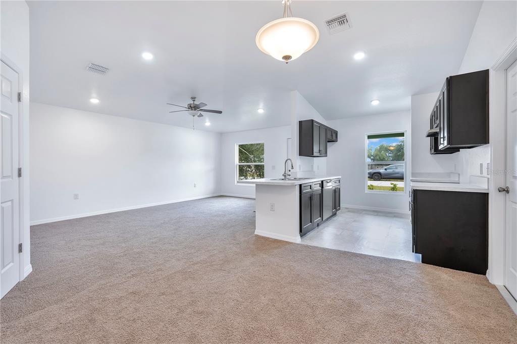 833 3rd Avenue Dundee, FL 33838 - Photo 13 of 37 a living room with furniture and a flat screen tv