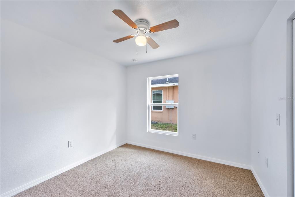 833 3rd Avenue Dundee, FL 33838 - Photo 21 of 37 an empty room with windows and ceiling fan