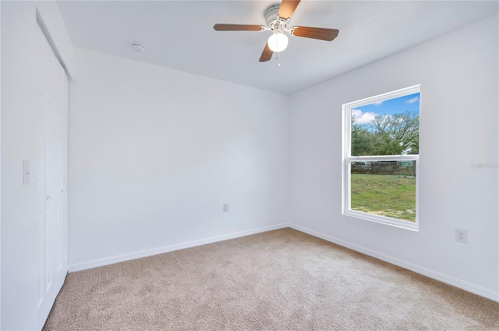 833 3rd Avenue Dundee, FL 33838 - Photo 24 of 37 an empty room with a window and a fan