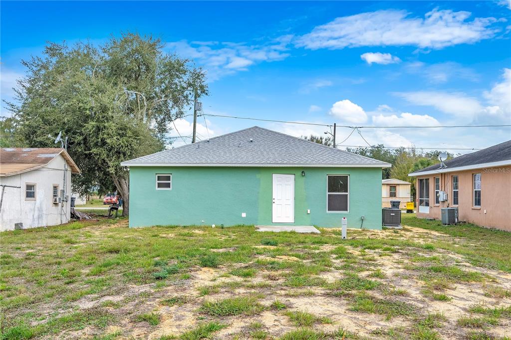 833 3rd Avenue Dundee, FL 33838 - Photo 28 of 37 a front view of house with yard and trees in the background