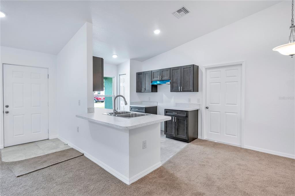 833 3rd Avenue Dundee, FL 33838 - Photo 8 of 37 a kitchen with a sink stove and cabinets