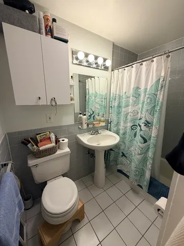 a bathroom with a sink toilet and a mirror