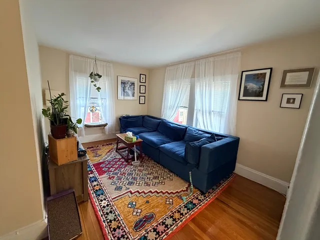 a living room with furniture and a rug