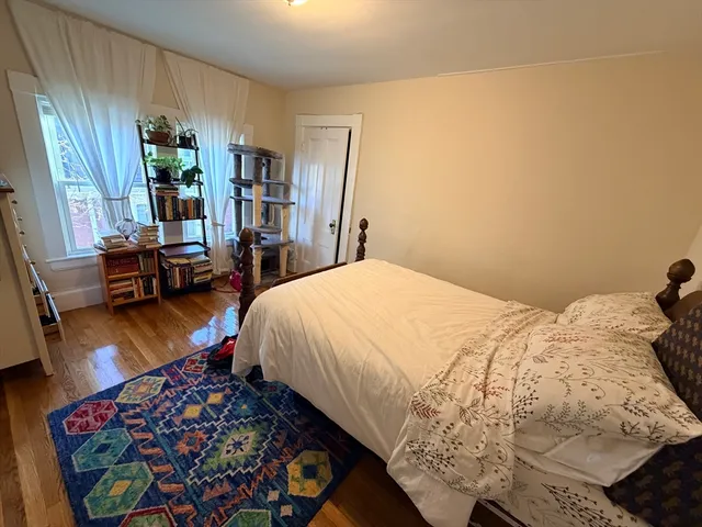 a bedroom with bed and a window