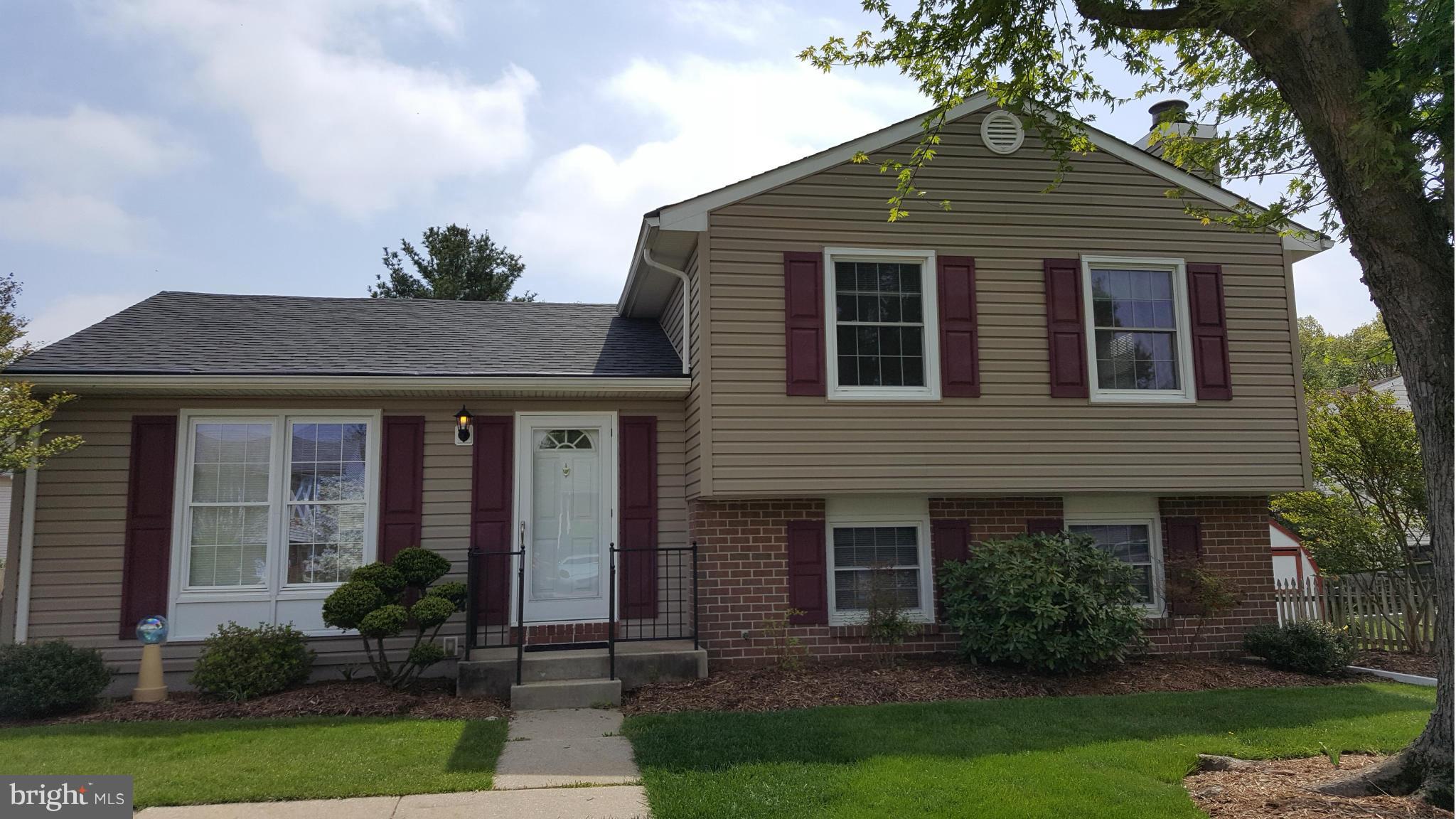9003 Transoms Road Baltimore, MD 21236 - Photo 1 of 29 a front view of a house with a yard and potted plants