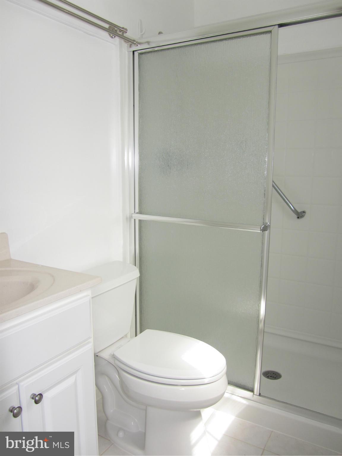 9003 Transoms Road Baltimore, MD 21236 - Photo 14 of 29 a white toilet sitting next to a bathroom sink
