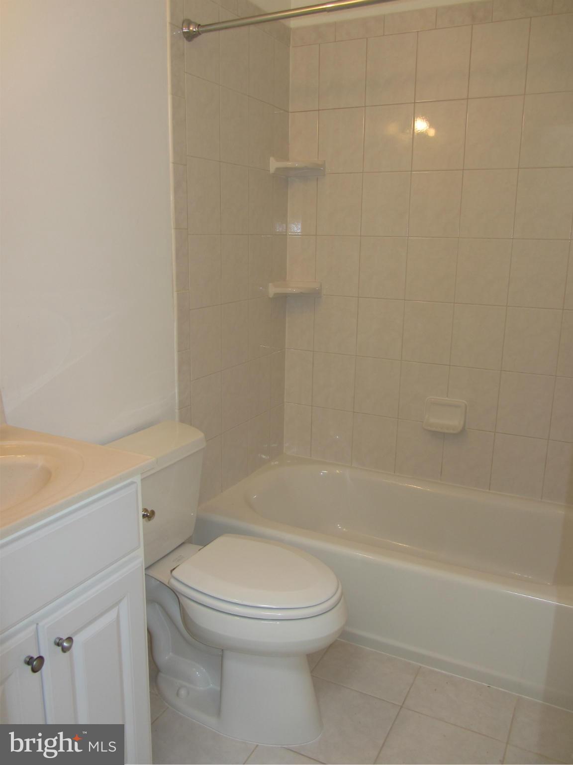 9003 Transoms Road Baltimore, MD 21236 - Photo 16 of 29 a bathroom with a toilet and a bath tub