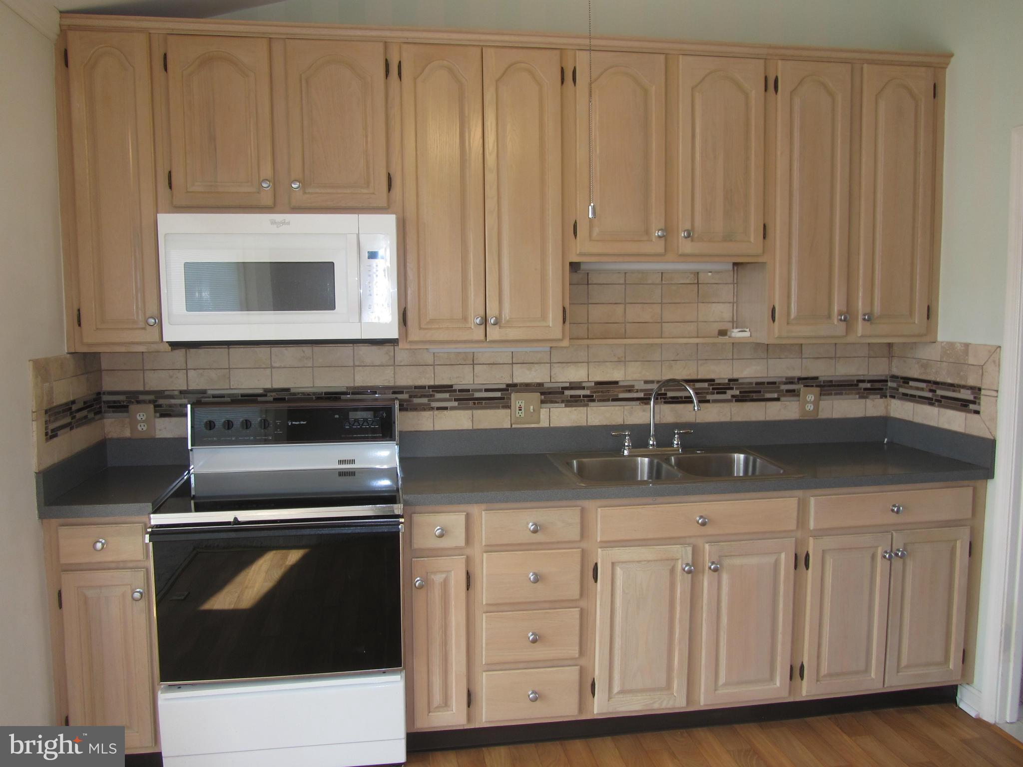 9003 Transoms Road Baltimore, MD 21236 - Photo 3 of 29 a kitchen with granite countertop white cabinets and sink