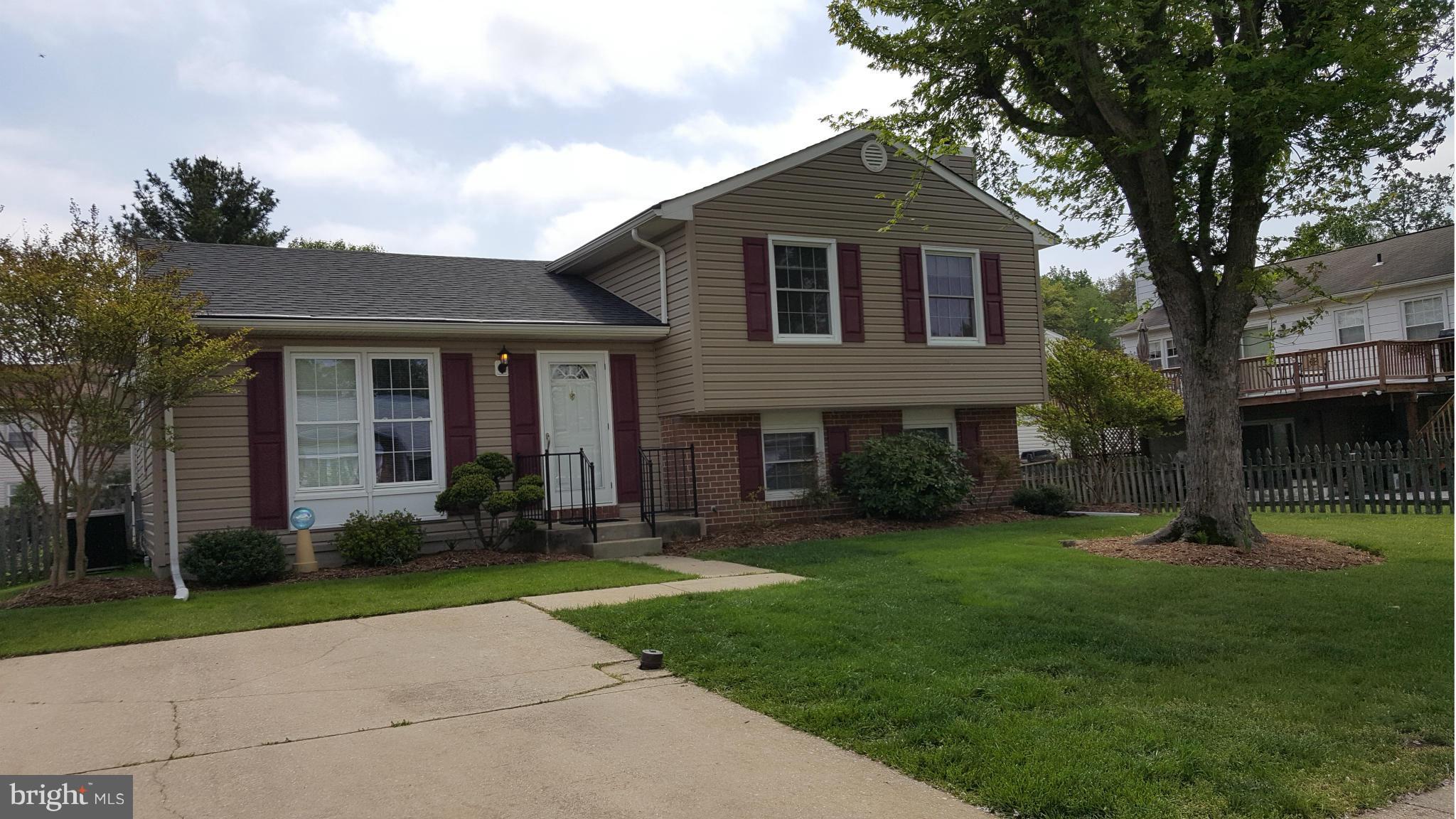 9003 Transoms Road Baltimore, MD 21236 - Photo 27 of 29 a front view of a house with a yard and trees