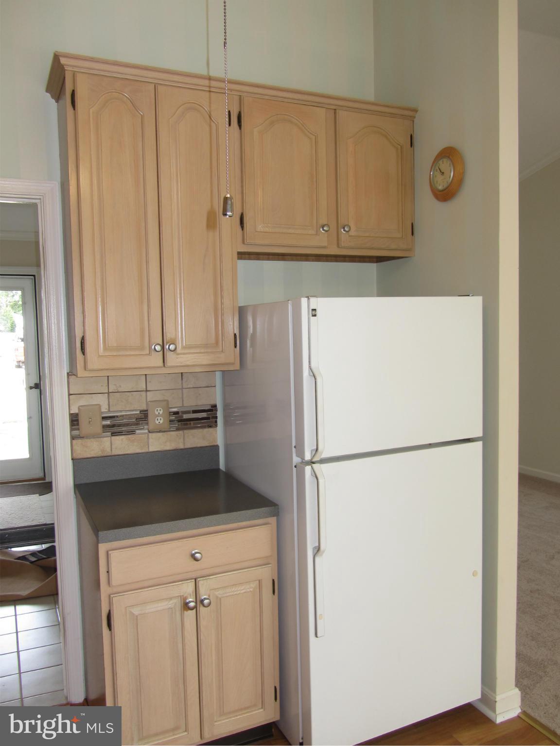 9003 Transoms Road Baltimore, MD 21236 - Photo 4 of 29 a white refrigerator freezer and a stove sitting inside of a kitchen