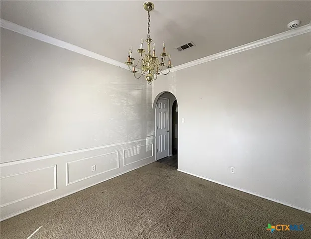 a view of a livingroom with a chandelier fan