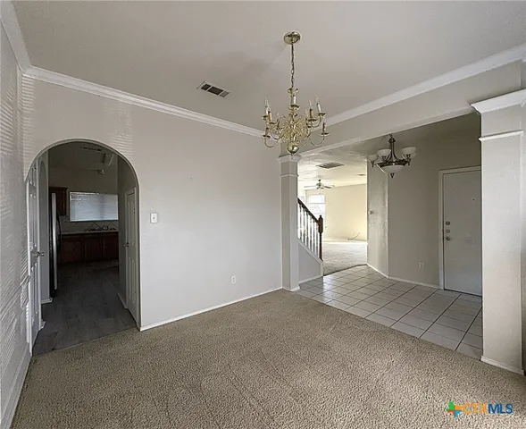 a view of a hallway with a chandelier