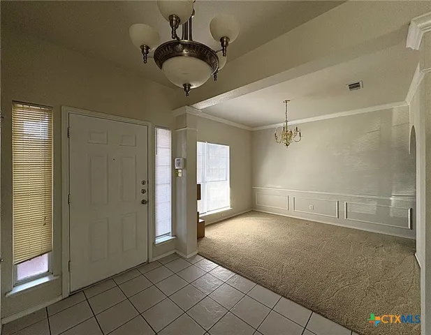 a view of an empty room and a window