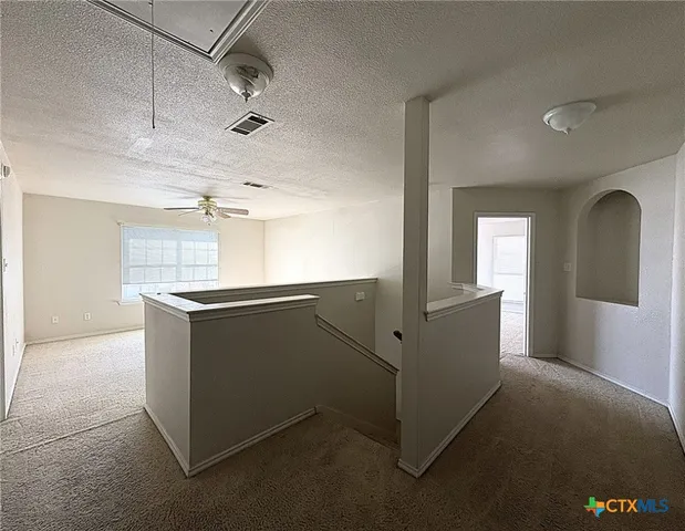 a kitchen with cabinets and wooden floor