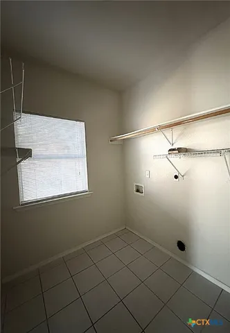 a bathroom with a window and a shower
