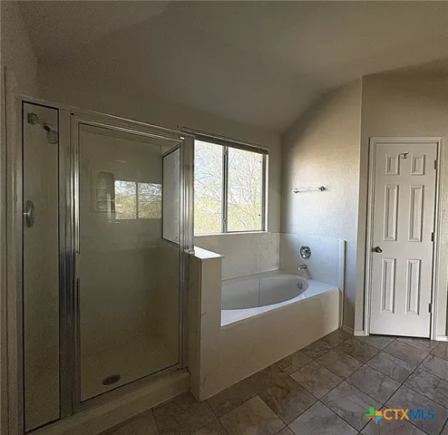 a bath tub sitting in a bathroom next to a window