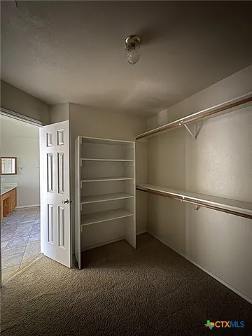 a view of an empty walk in closet