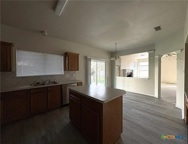 a kitchen with stainless steel appliances granite countertop a stove and a sink