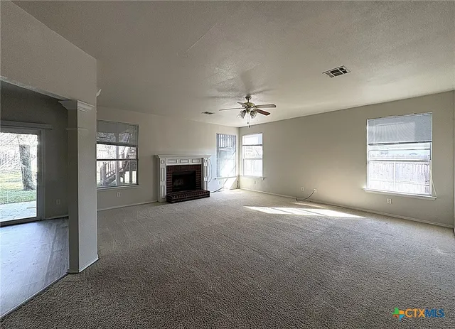 a view of empty room with a fireplace