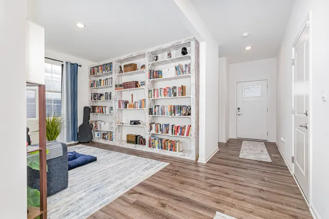 a living room with furniture and a book shelf
