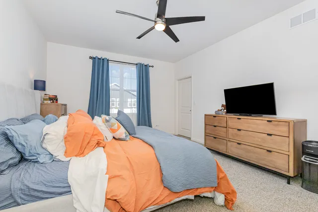 a bedroom with a bed and flat screen tv