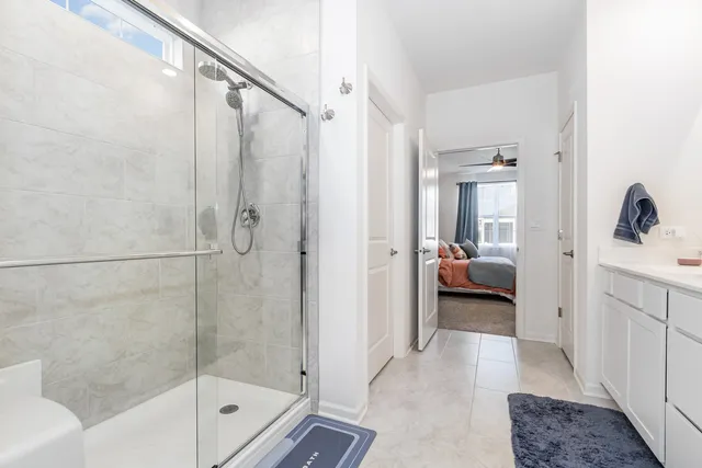 a en suite bathroom with a tub shower and mirror