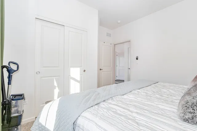 a bedroom with a bed and a flat tv