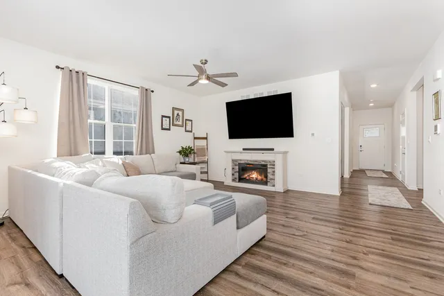 a living room with furniture a fireplace and a flat screen tv