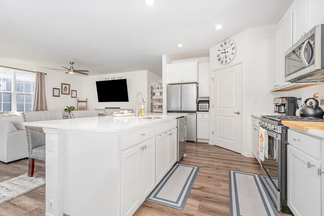 a kitchen with a sink stove and refrigerator