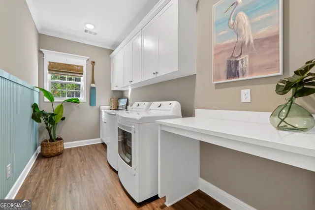 a utility room with sink dryer and washer