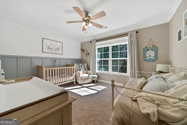 a bedroom with a bed and a large window