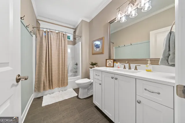 a spacious bathroom with a double vanity sink mirror and toilet