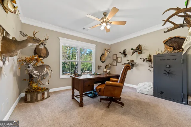 a view of a workspace with furniture and a window