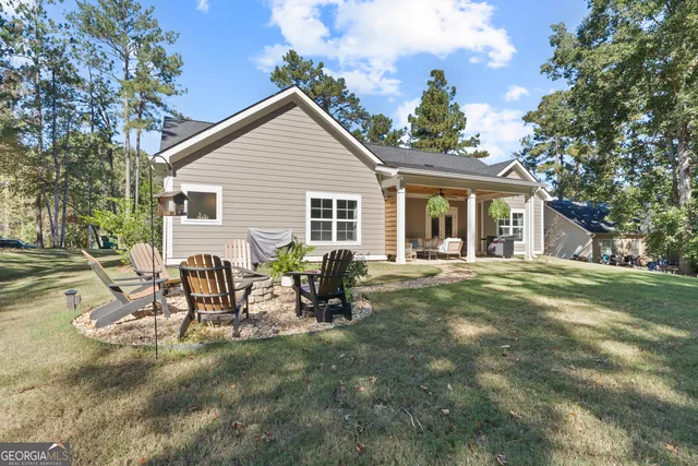 a view of a house with backyard and sitting area