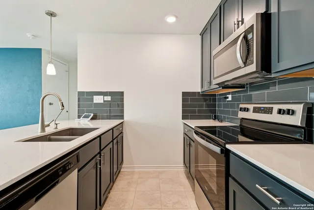 a kitchen that has a sink and a stove