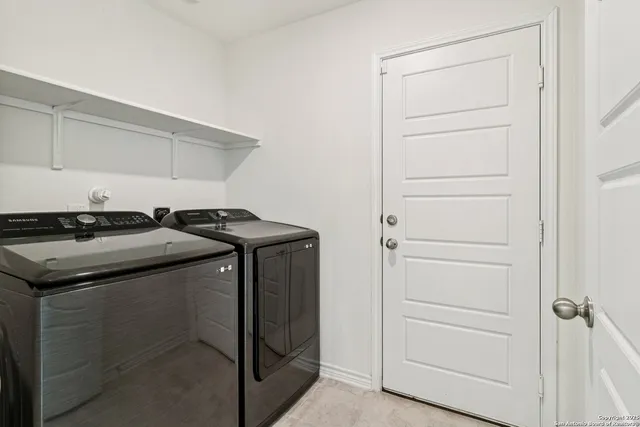 a utility room with washing machine