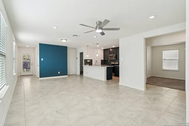 a view of a kitchen with a sink and a refrigerator