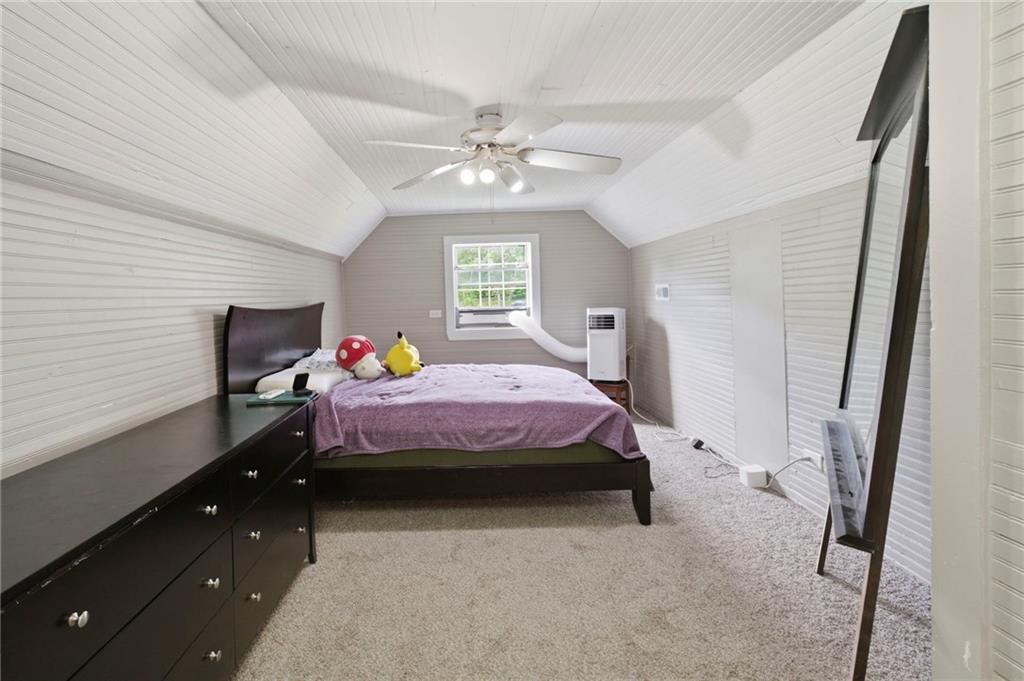 400 Sam Love Road Rocky Face, GA 30740 - Photo 22 of 29 a bedroom with a bed and a chandelier