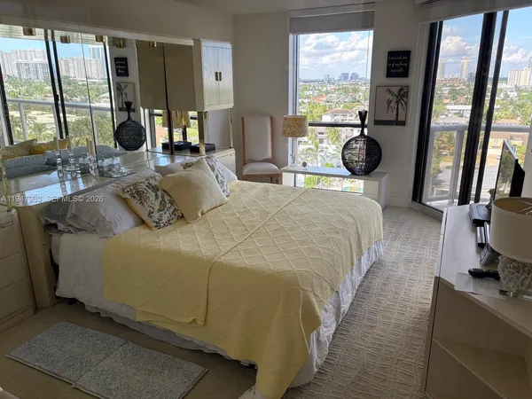 a bedroom with a bed and a large window