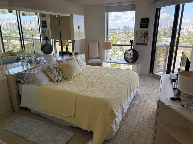 a bedroom with a bed and a large window