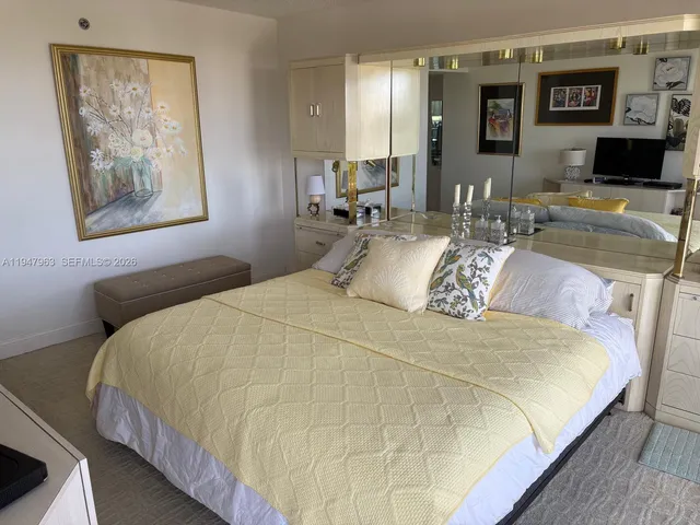 a bedroom with bed and table