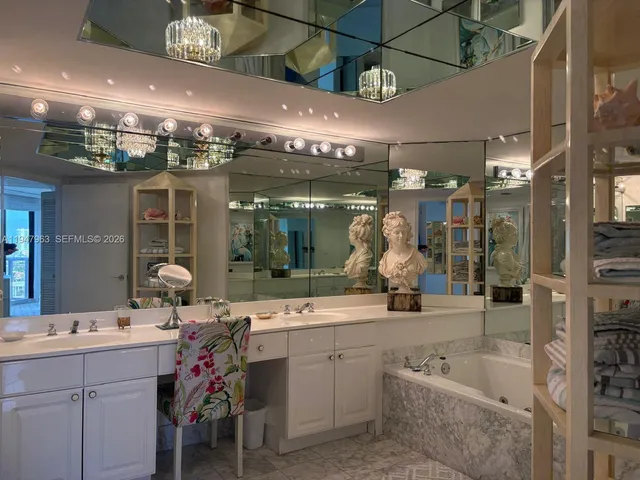 a bathroom with a sink a large mirror and shower